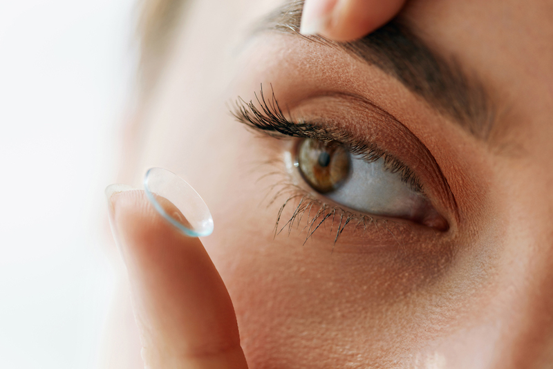 A woman putting in a contact lens