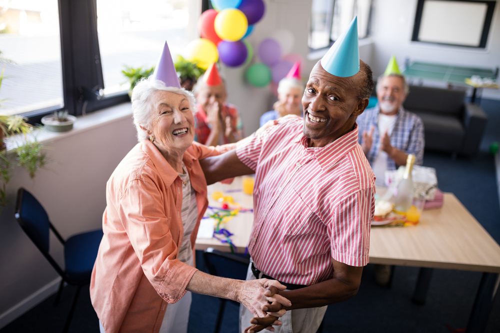 Photo of two seniors dancing at a party.