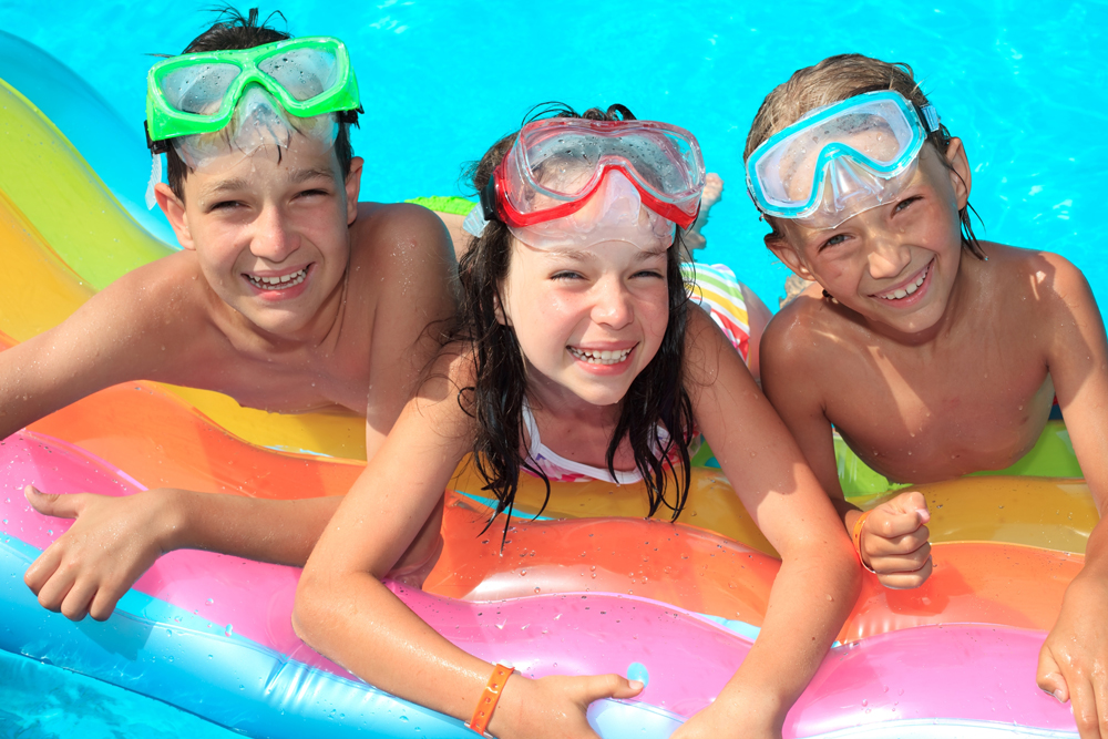 Three kids in a swimming pool